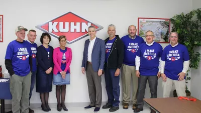 Congressman Anthony Brindisi stands with employees of Kuhn North America's Vernon, New York, Regional Distribution Center.