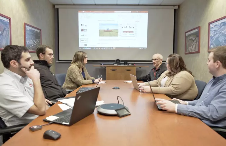 kuhn employees meeting in a conference room