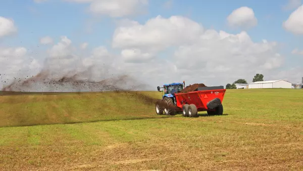 SL 124 spreading manure in the field.