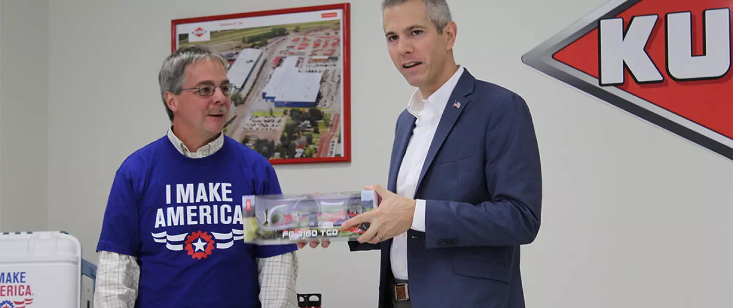 Jerry Smith presents Representative Brandisi with a KUHN scale model to commemorate his visit.