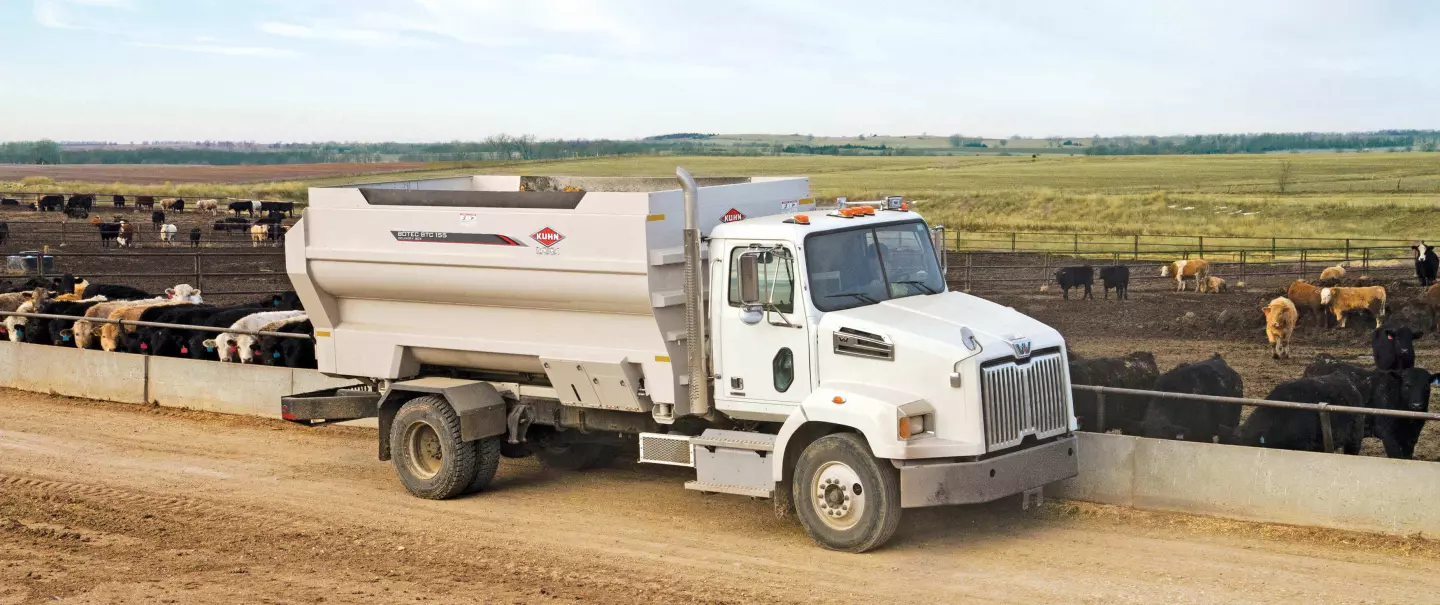 BTC 155 truck-mounted delivery box delivering feed to beef cattle.